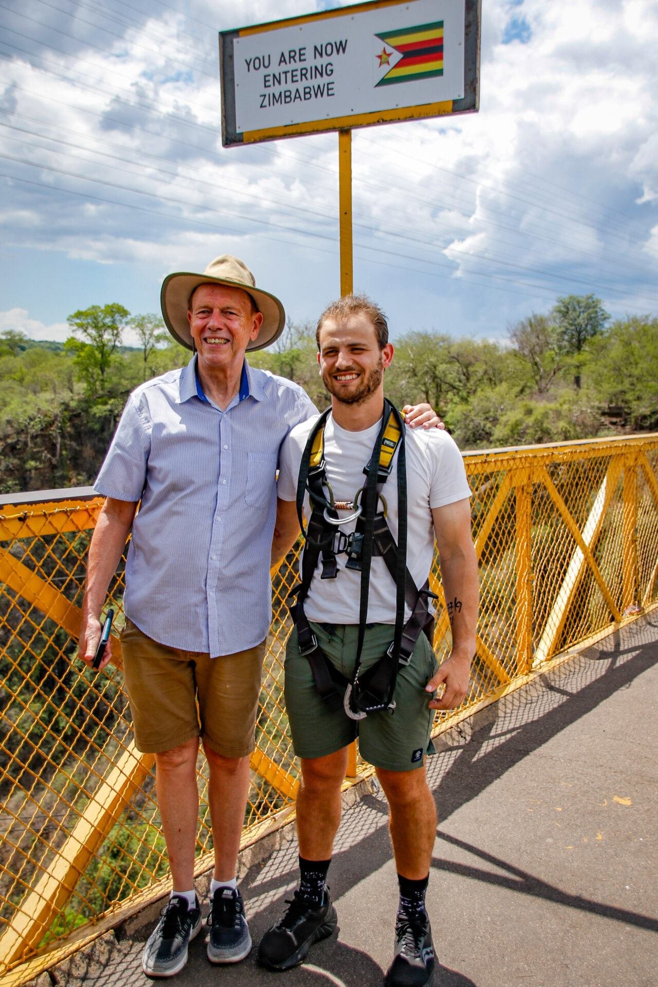 Travellers at the Zimbabwe border marker near Victoria Falls