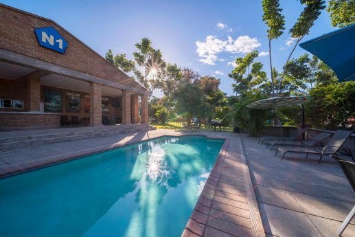 Outdoor swimming pool at N1 Hotel Victoria Falls