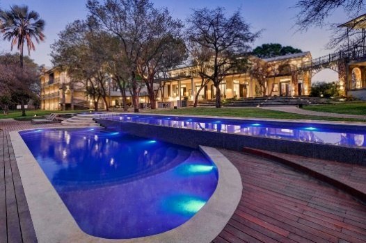 Swimming pool at Palm River Hotel, Victoria Falls, at dusk