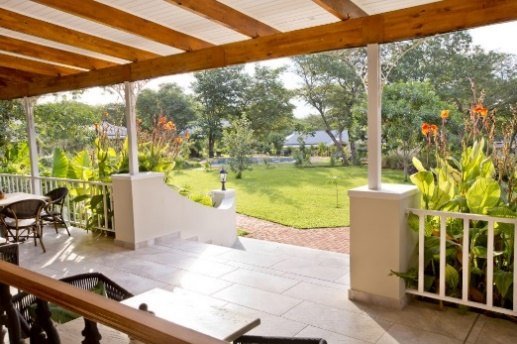 Veranda overlooking the gardens at Pioneers Lodge, Victoria Falls