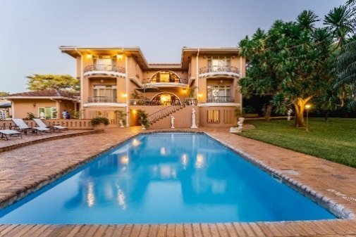 Pool and manor house at The Victorian Manor, Victoria Falls