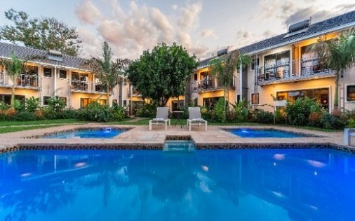 Swimming pool and garden at Victoria Falls Oasis
