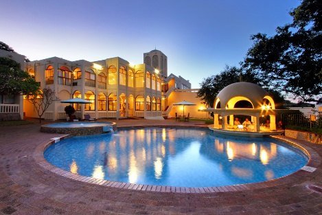 Victoria Falls Rainbow Hotel and pool lit at dusk