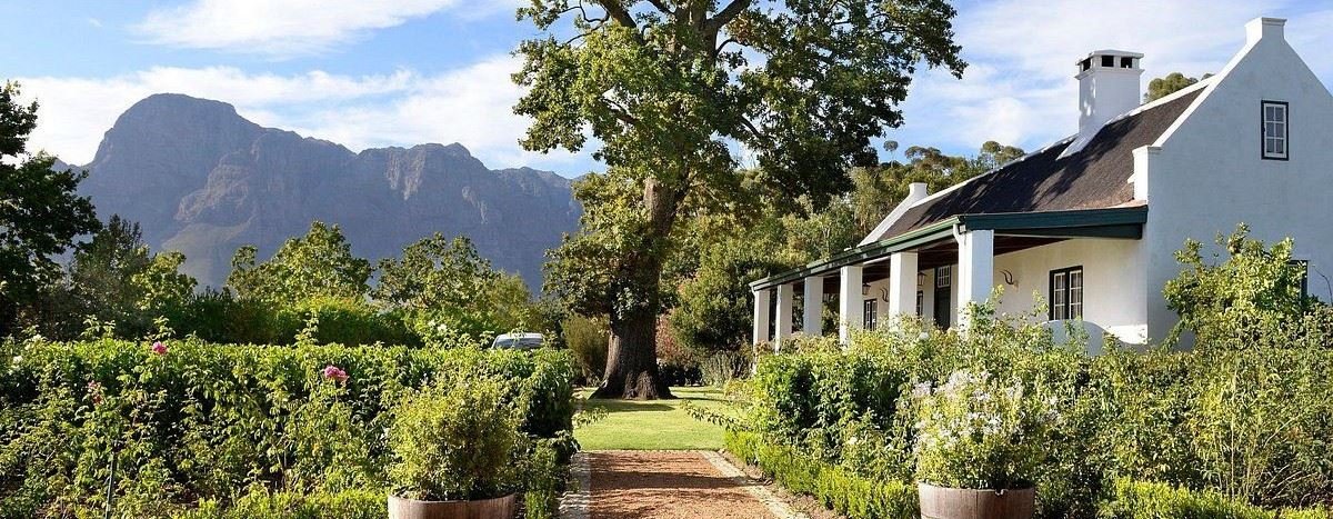 White Cape Dutch homestead among gardens and mountains