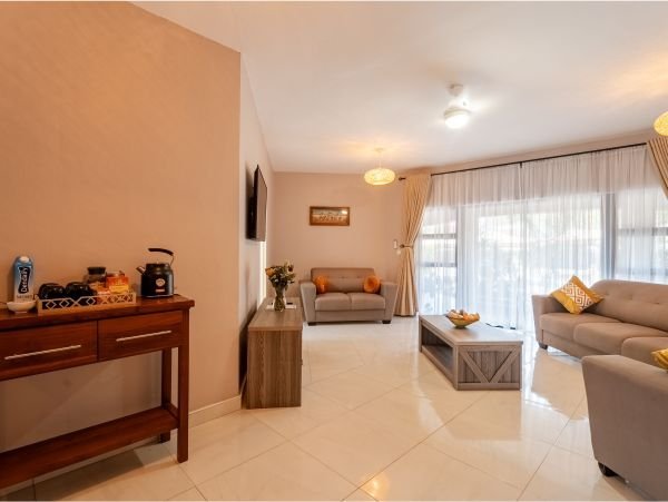 Suite lounge with a sofa and dining table at Bishop House