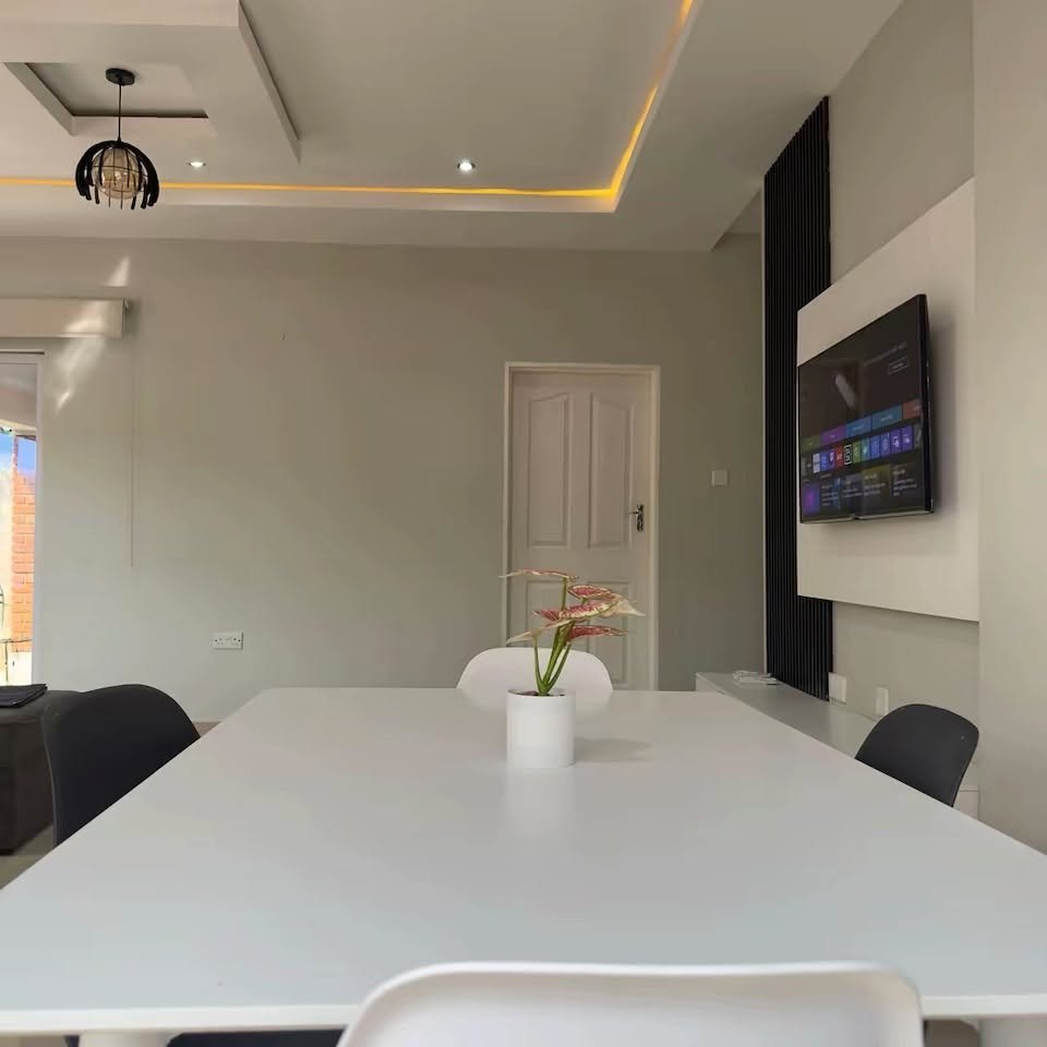 Dining area and TV in a Bonga Villa self-catering apartment, Victoria Falls