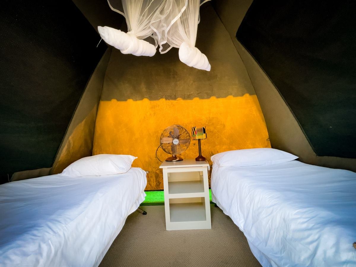 Pre-pitched safari tent interior for camping in Victoria Falls Zimbabwe