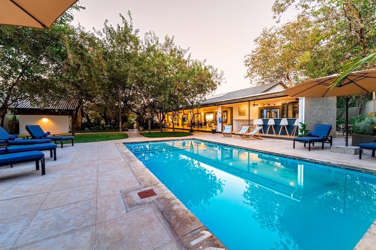 Swimming pool and guest rooms at Kabakwe Guest Lodge, Victoria Falls
