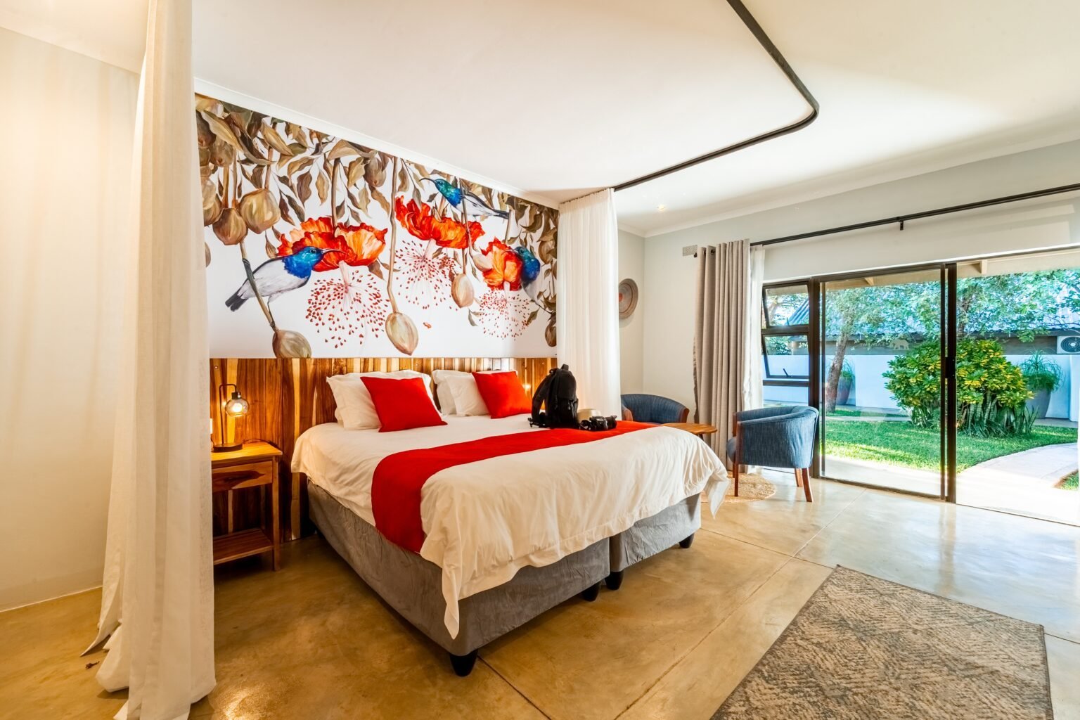 Deluxe room with a mural wall at Kabakwe Guest Lodge