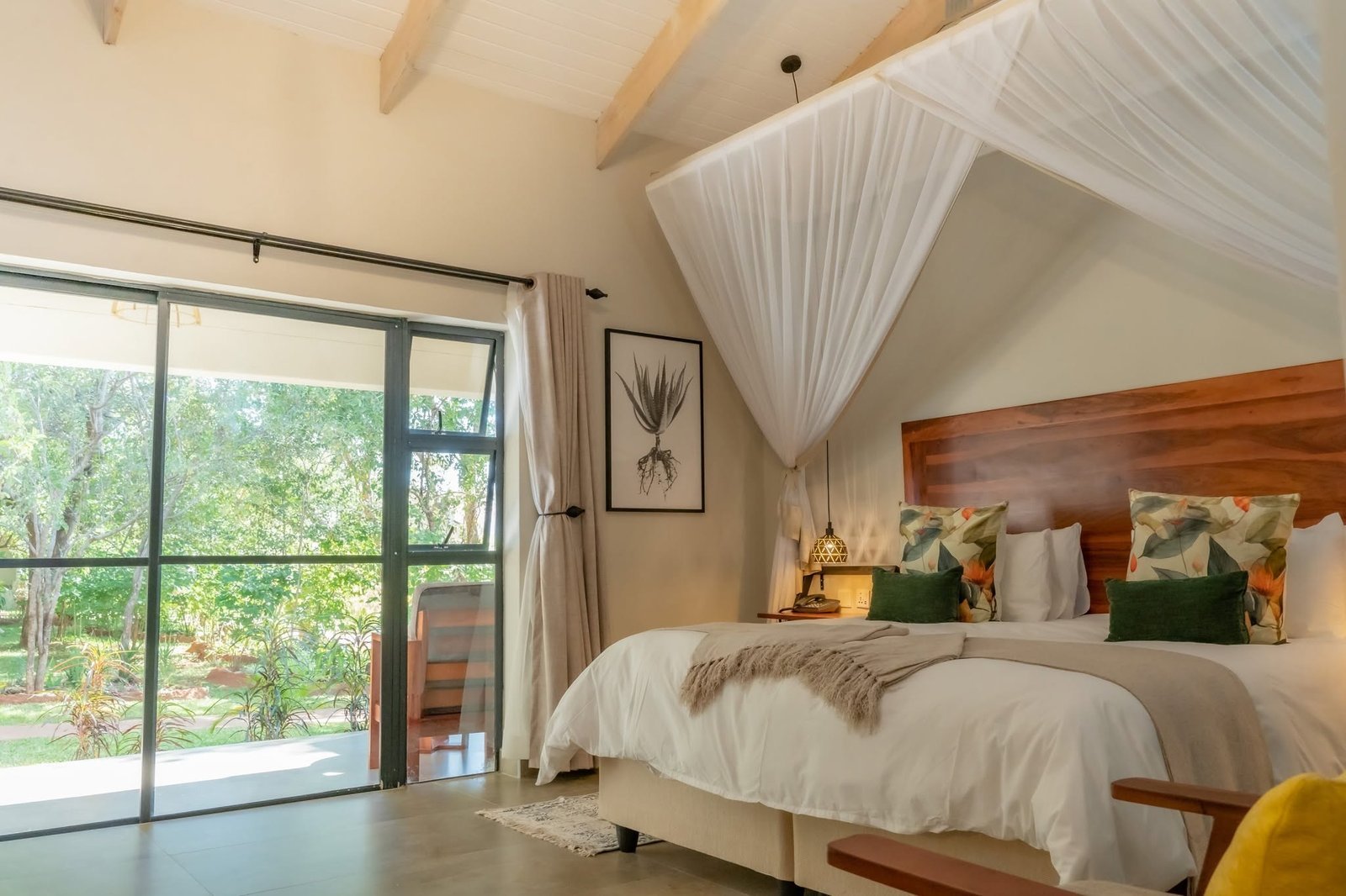 Room with mosquito net and garden view at Kasambezi Lodge