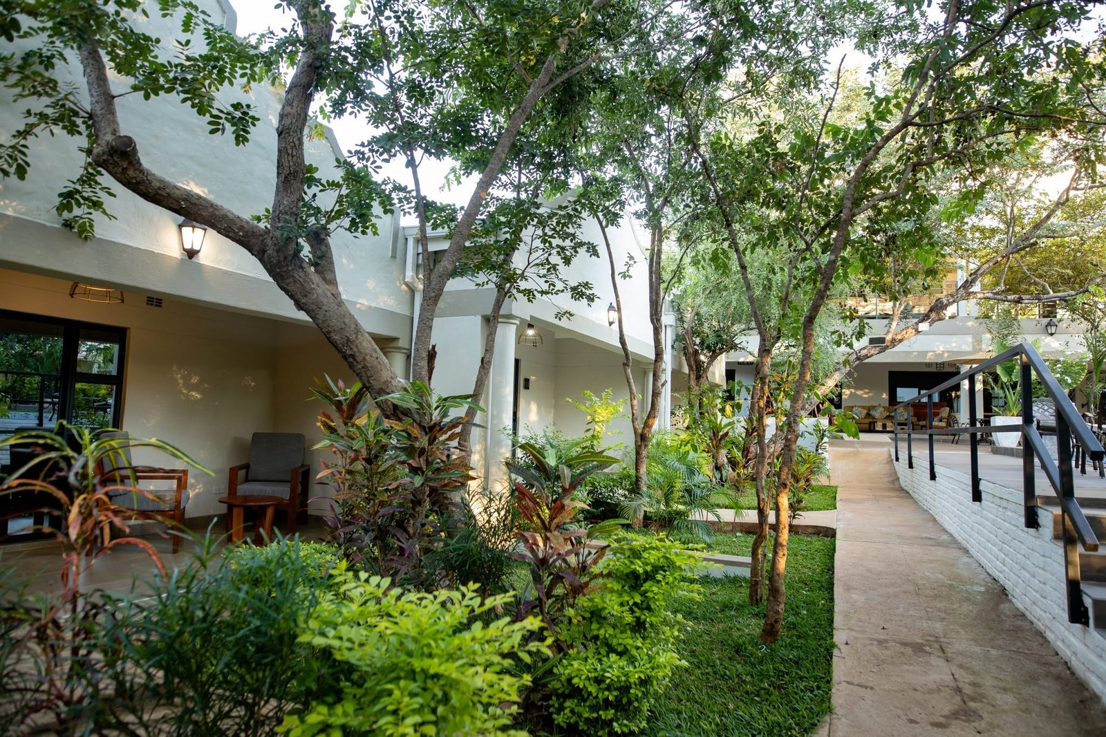 Gardens and shaded walkways at Kasambezi Lodge