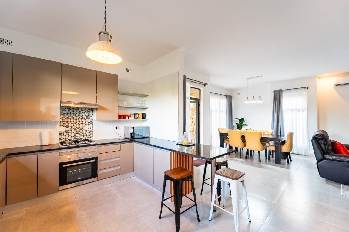 Open-plan kitchen, dining and lounge at Sea of Dreams apartments