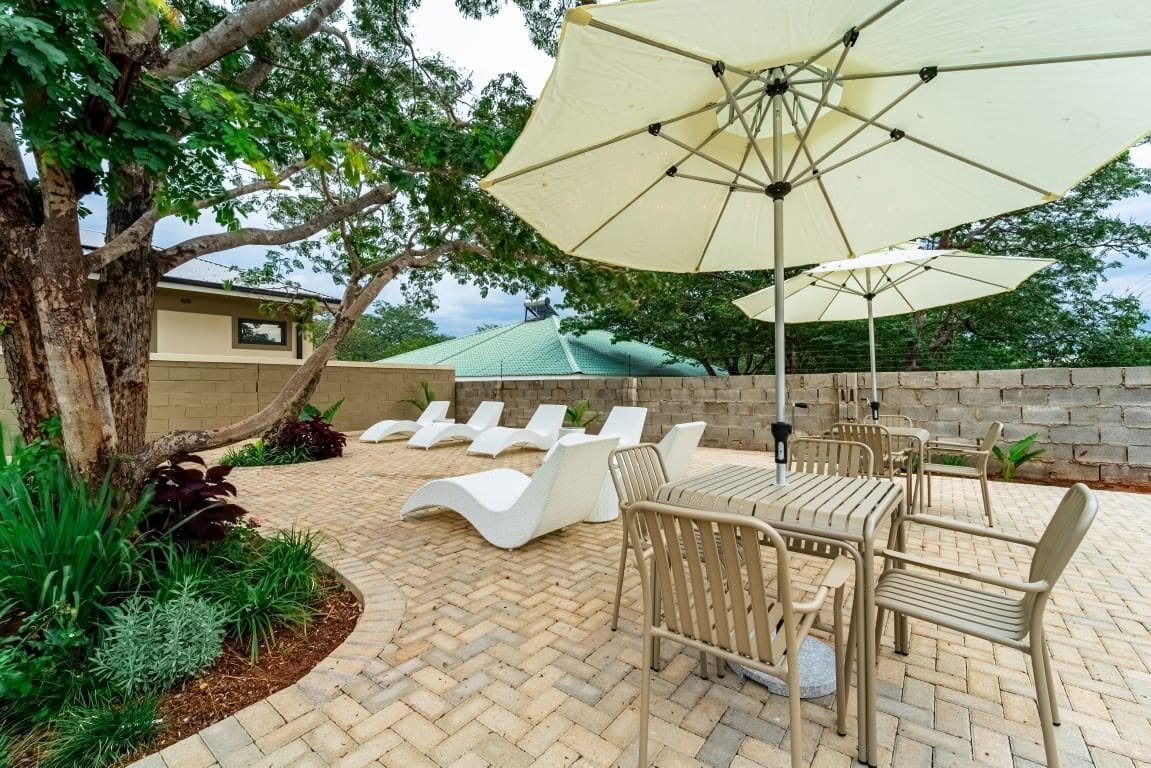 Garden seating under an umbrella at Sea of Dreams