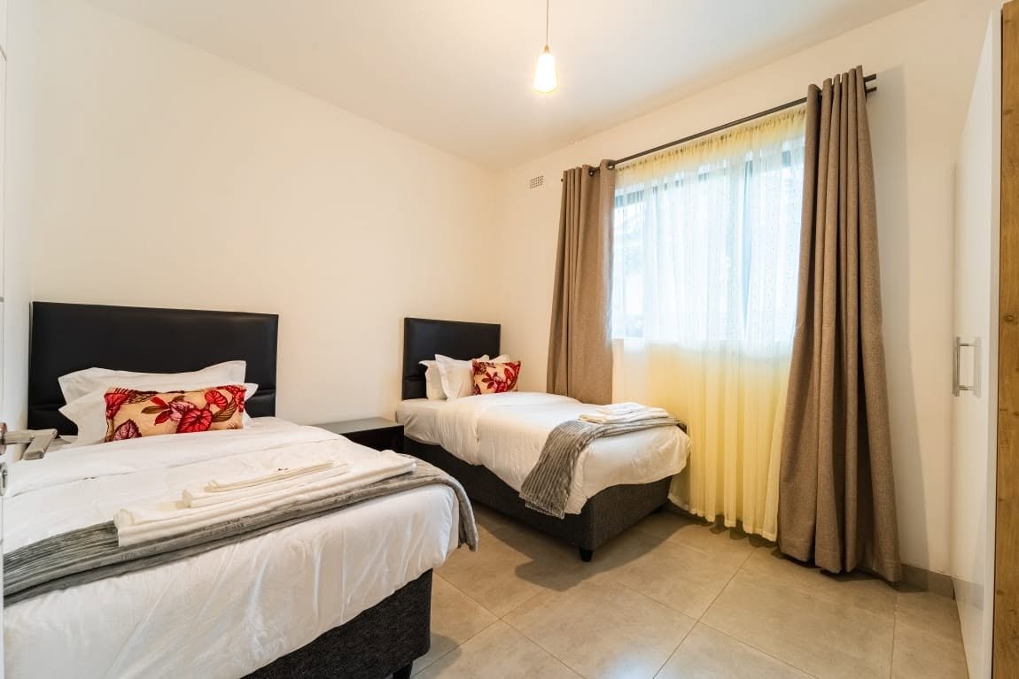Twin bedroom at Sea of Dreams apartments, Victoria Falls