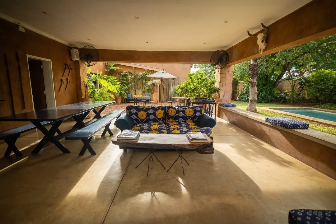 Covered outdoor lounge beside the pool at Tabokana House, Victoria Falls