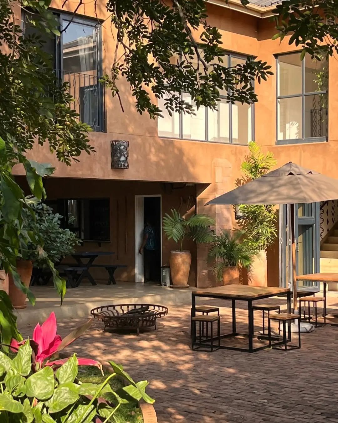Courtyard with a fire pit in the evening at Tabokana House