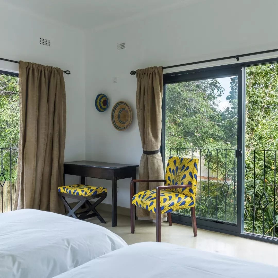 Bedroom with sliding doors onto the garden at Tabokana House