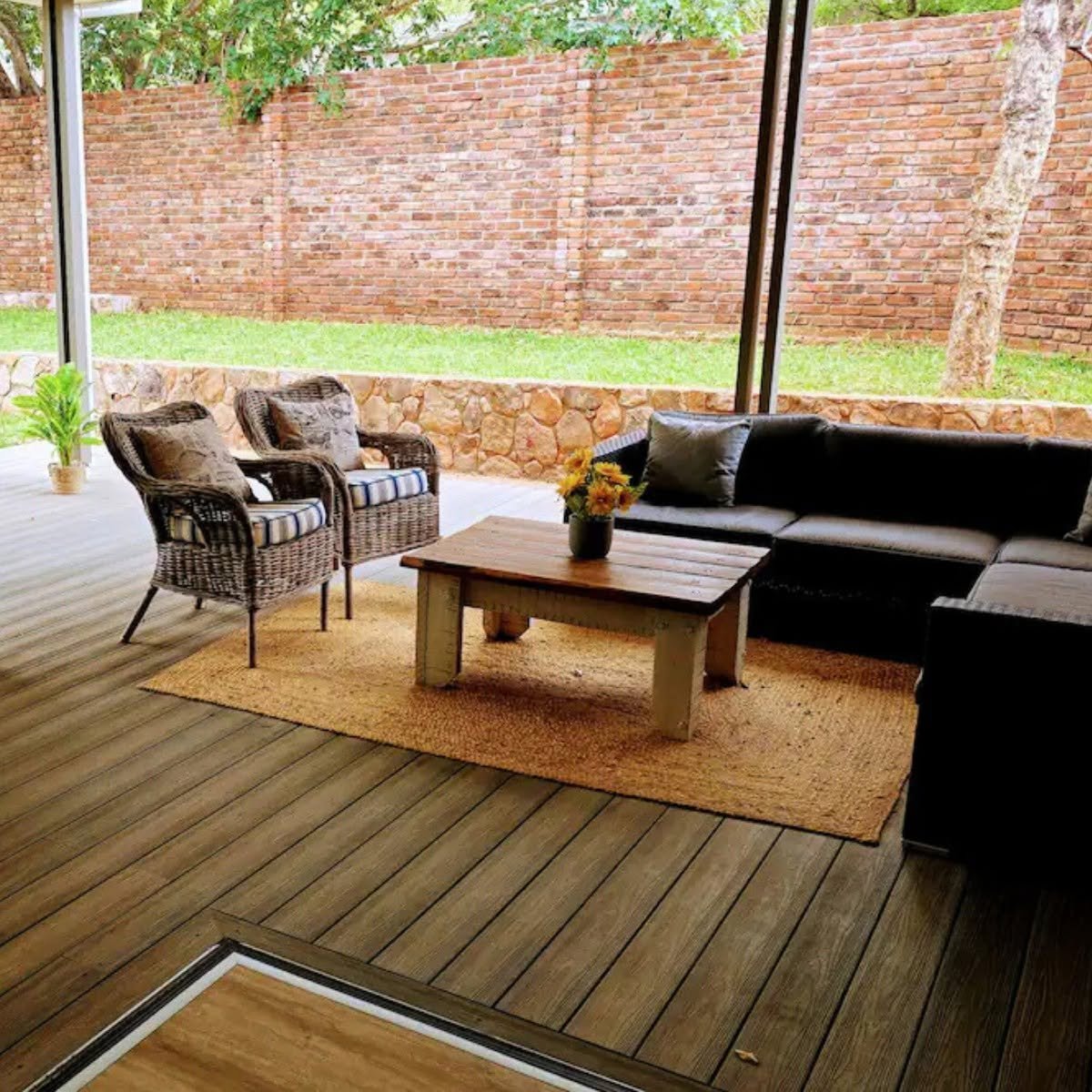 Covered veranda lounge at The Outpost self-catering apartments, Victoria Falls