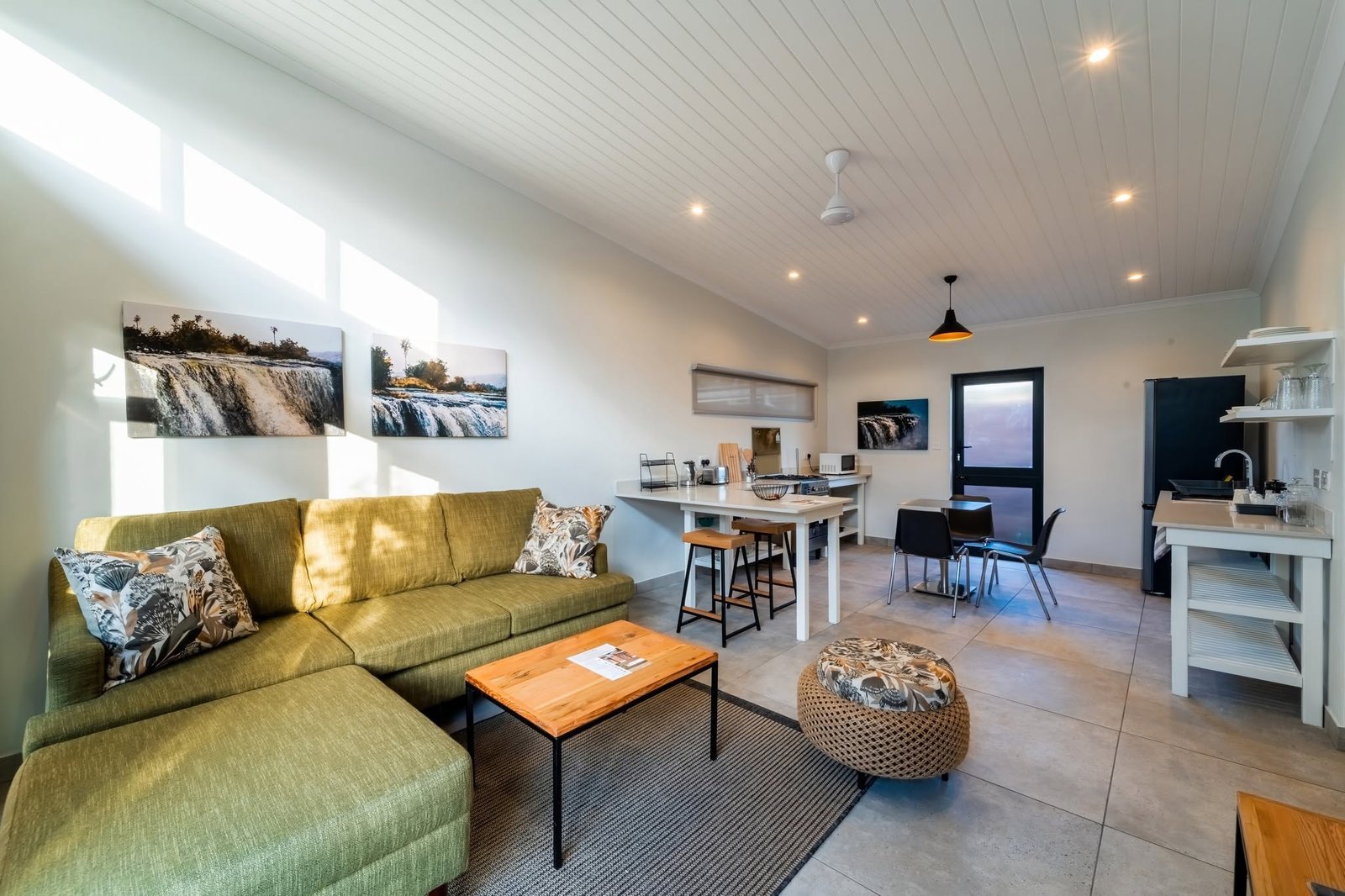 Open-plan lounge and dining area in a villa at The Pods