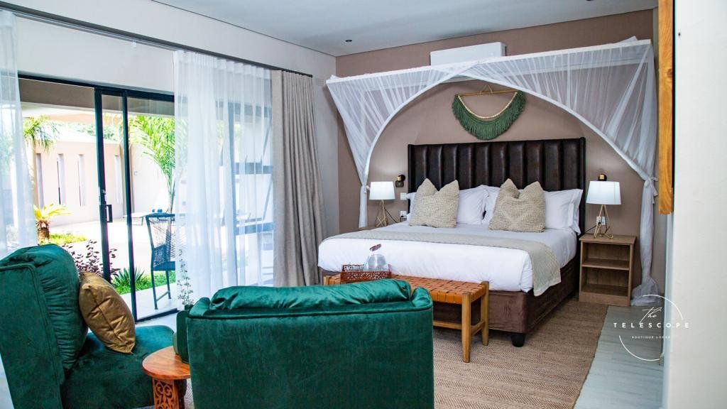 Executive room with a green sofa at The Telescope Boutique Lodge