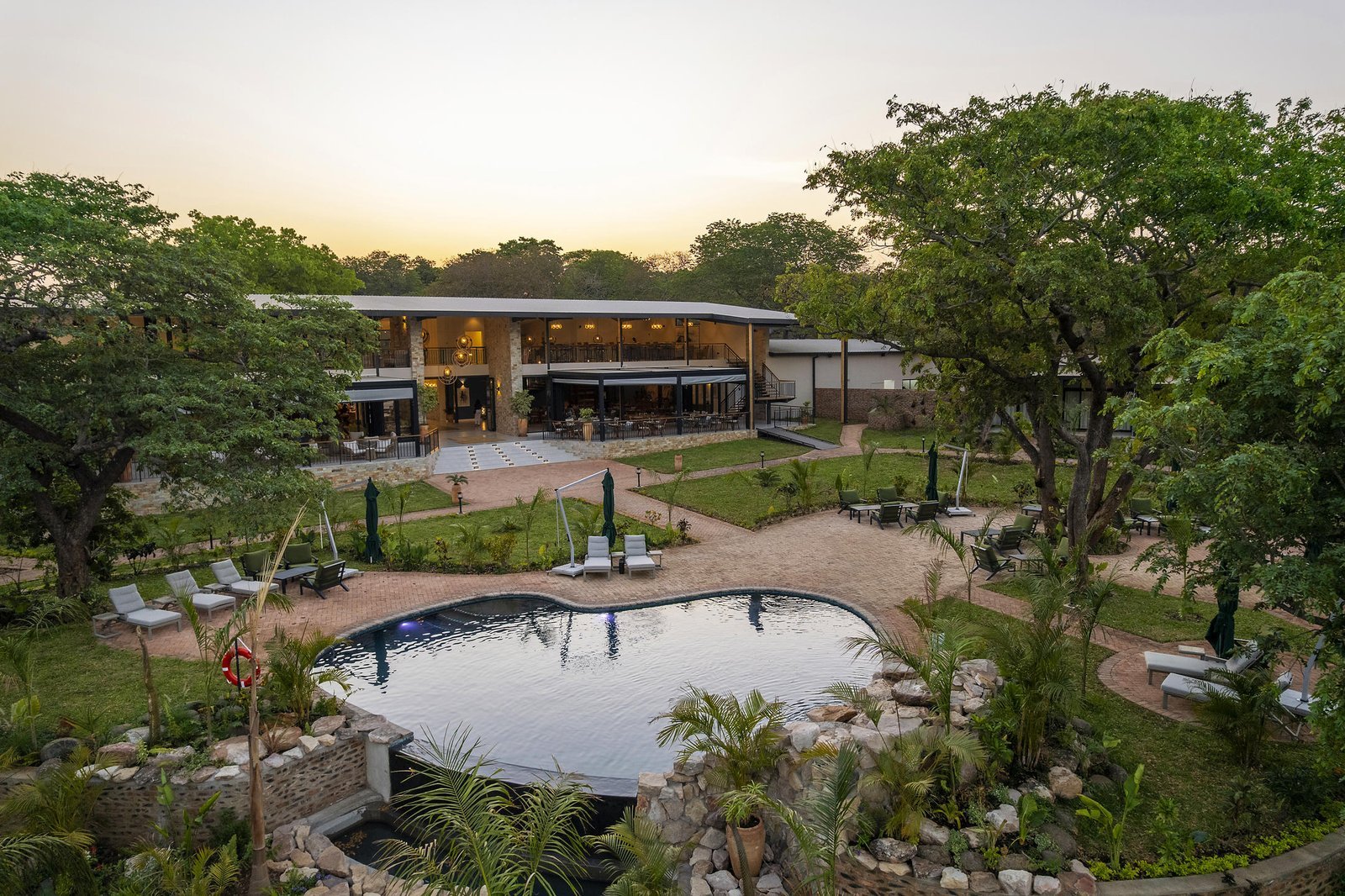 Courtyard and pool at Waterfalls Lodge at dusk