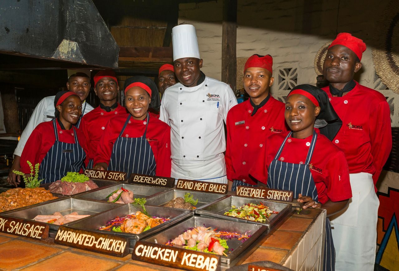 The Boma chefs and serving team behind the buffet counter