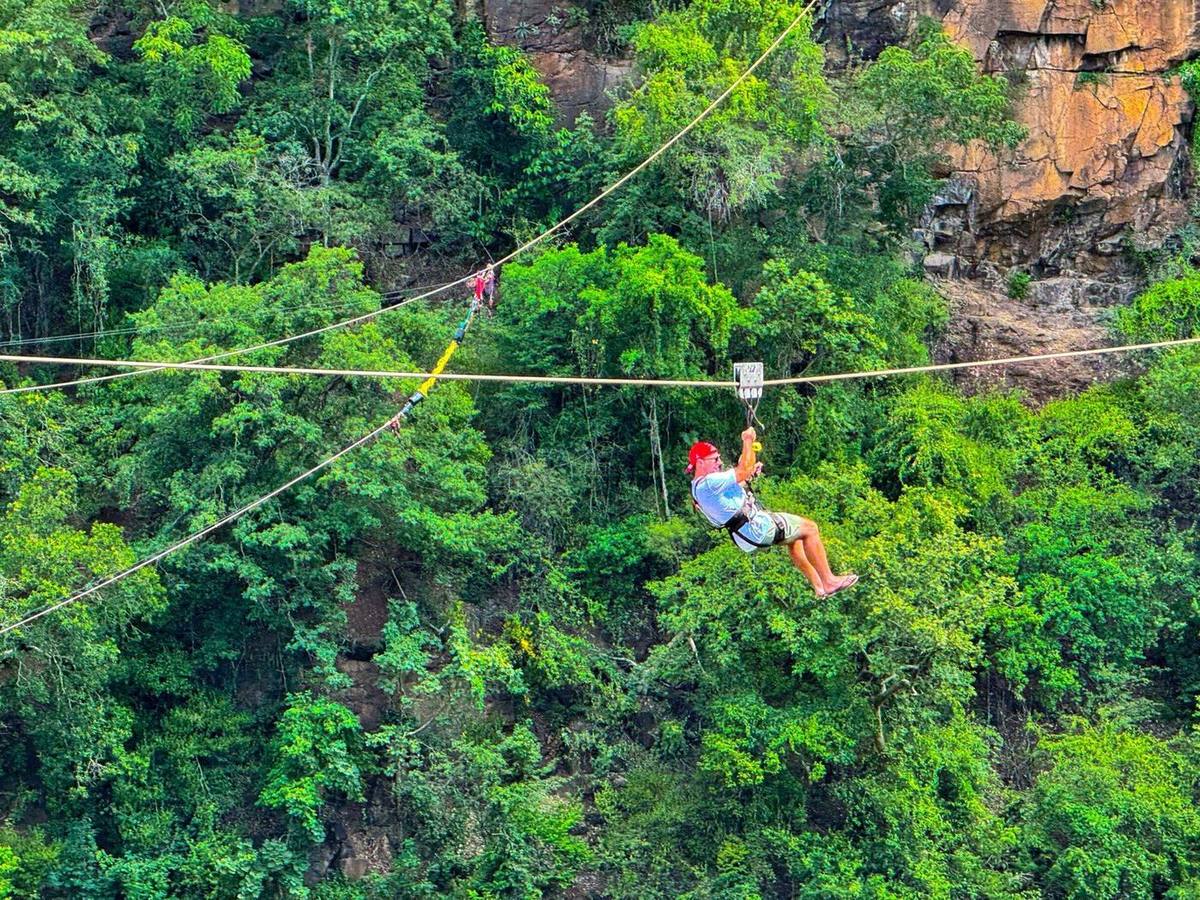 Guest on the Victoria Falls Bridge slide zipline above the Batoka Gorge