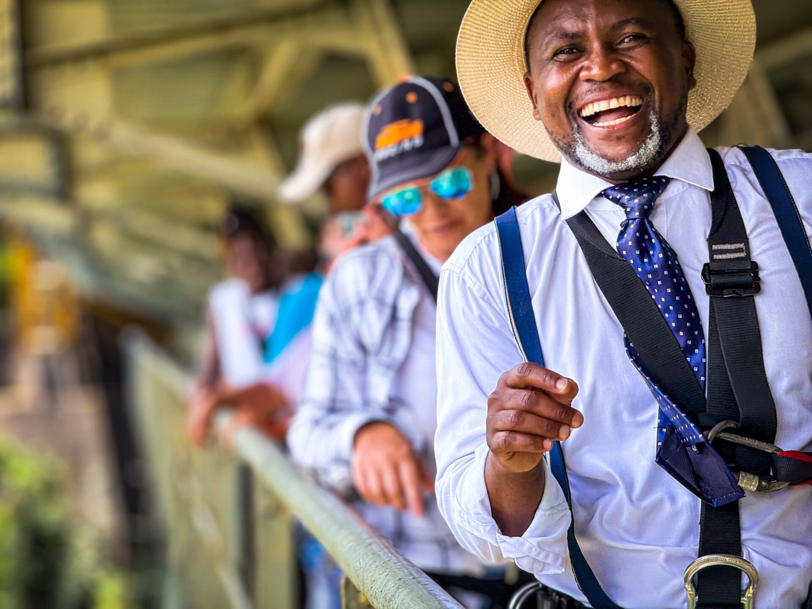 A bridge tour guide with guests on the Victoria Falls Bridge