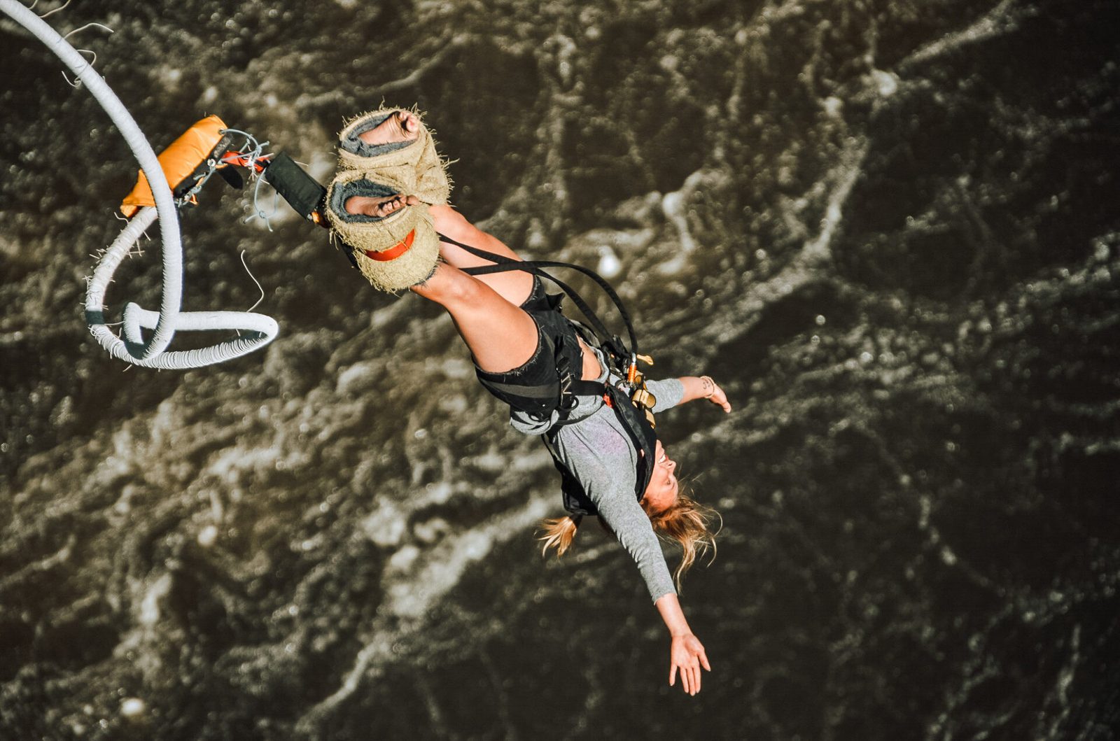 Bungee jumper upside down mid-fall above the Batoka Gorge