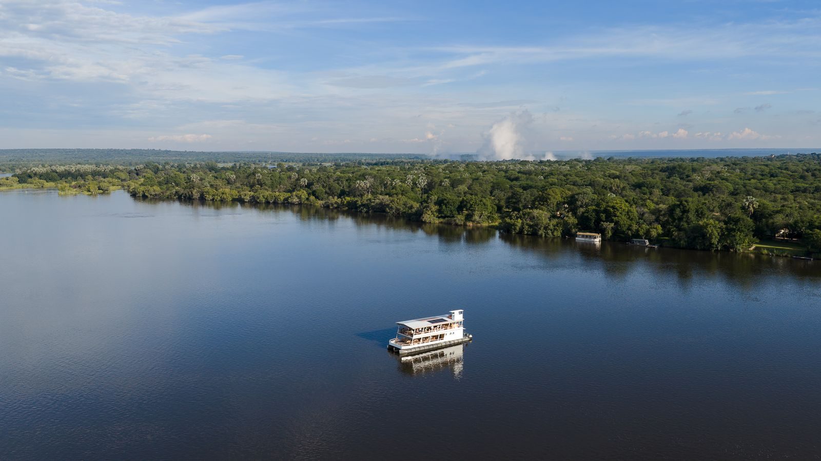 Cruise boat on the wide Zambezi River at dusk