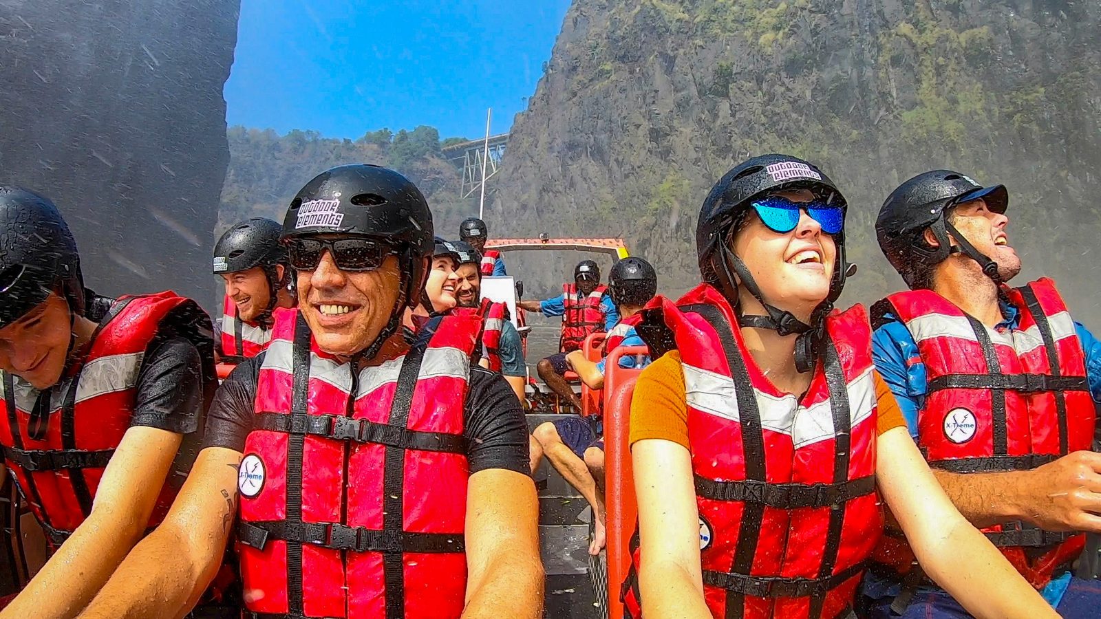Guests in life jackets and helmets aboard the adventure jet boat