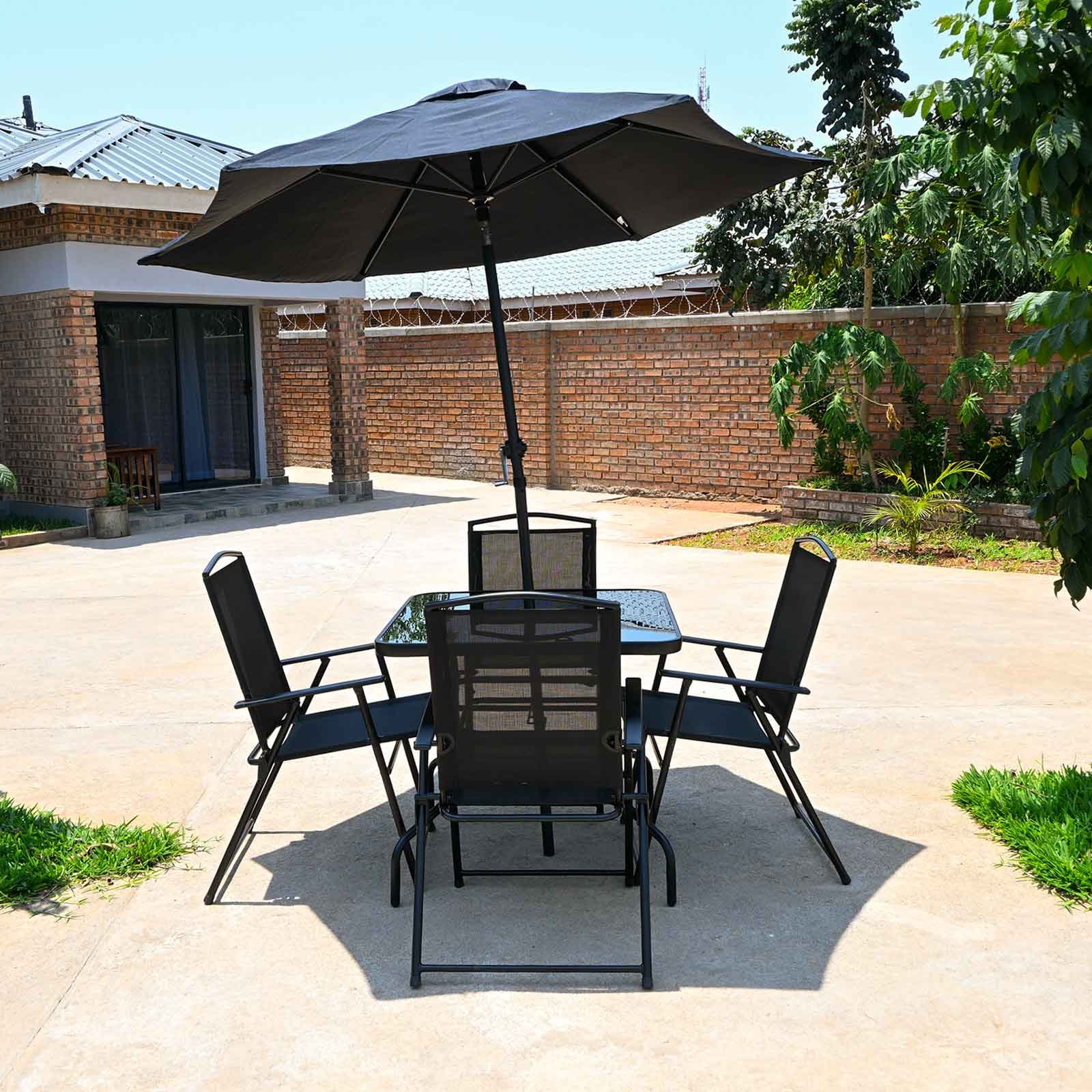 Shaded outdoor dining table on the terrace at Dade House