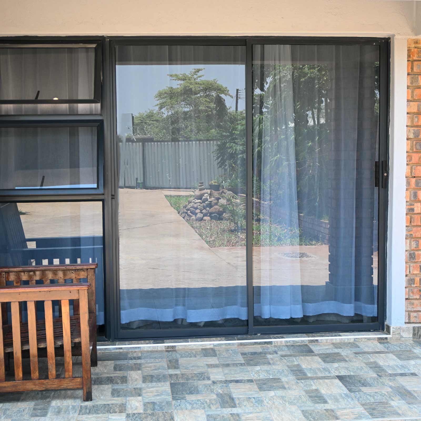 Sliding doors from a room onto the paved terrace at Dade House