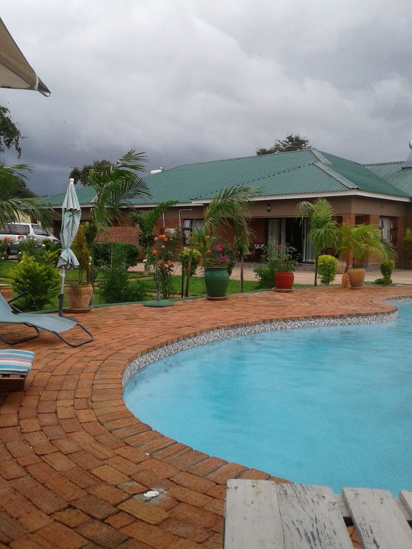 Garden bungalows and pool at Dzimbahwe House