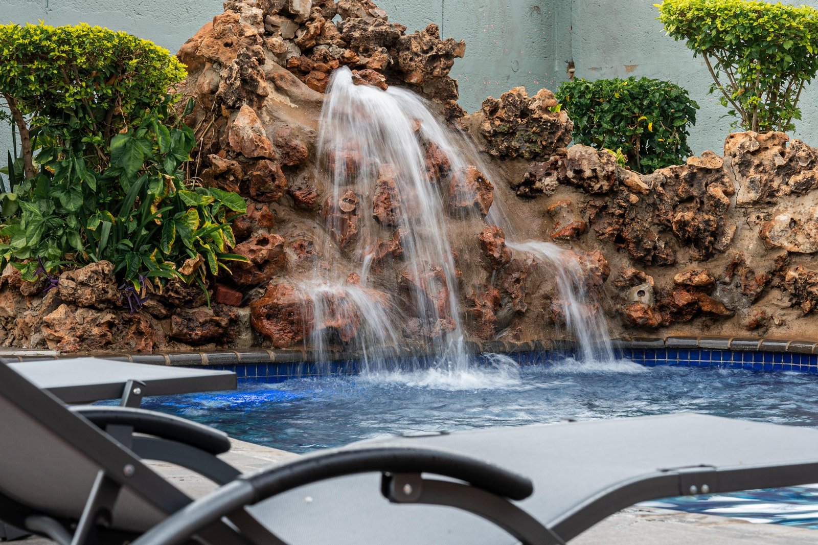 Swimming pool with a rock waterfall at Elena House, Victoria Falls