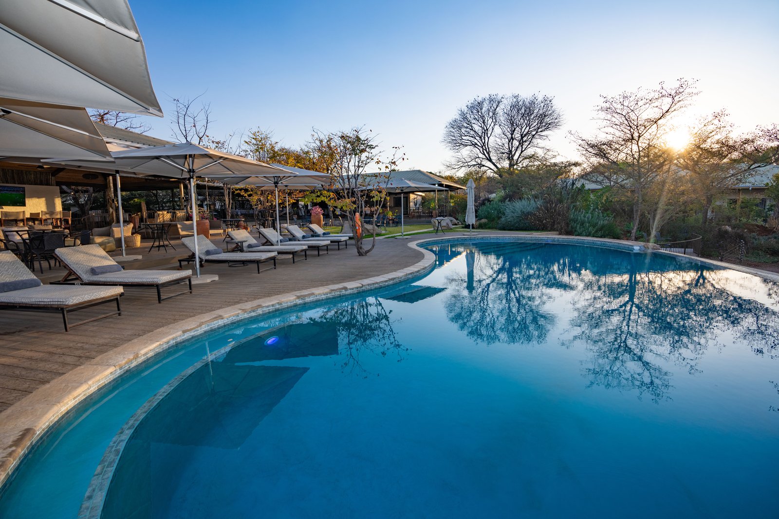 Swimming pool and sun loungers in front of Insika Lodge, Victoria Falls