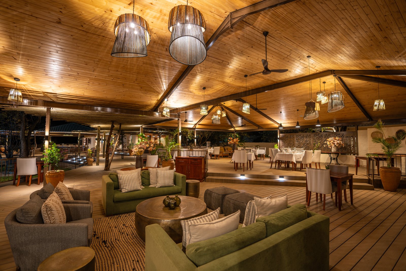 Lounge and dining area under the timber roof at Insika Lodge