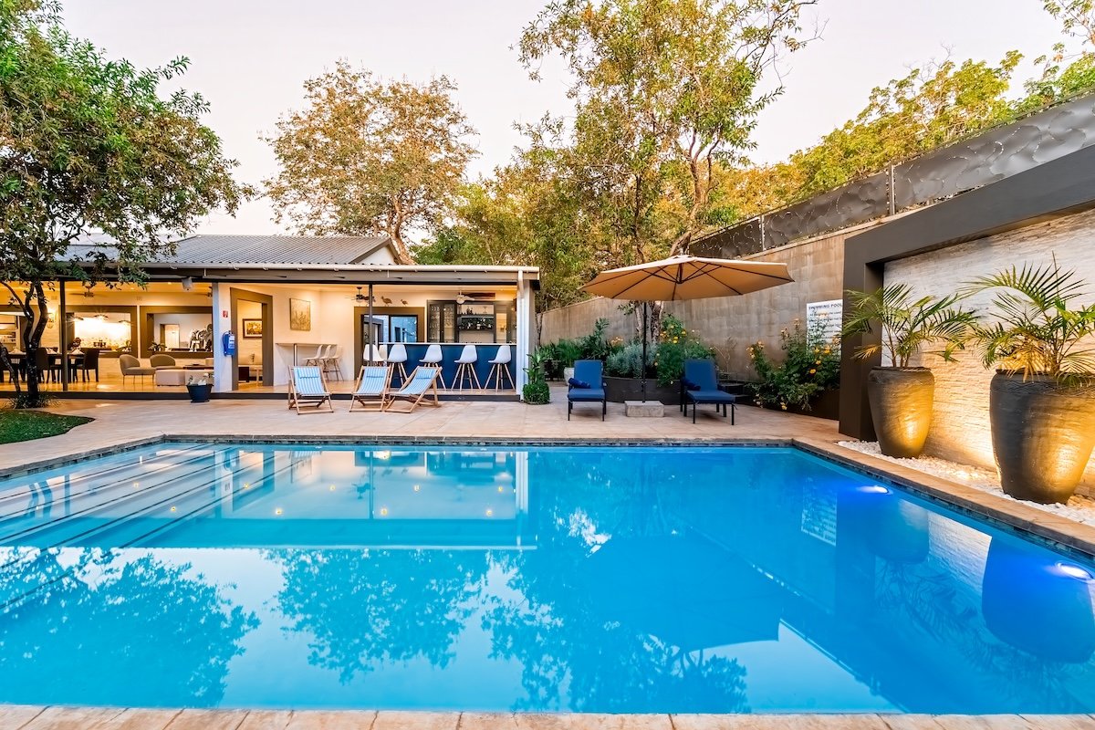 Swimming pool and loungers at dusk at Kabakwe Guest Lodge