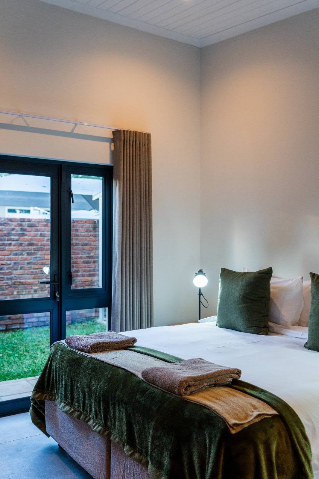 Bedroom with garden doors at The Pods Victoria Falls