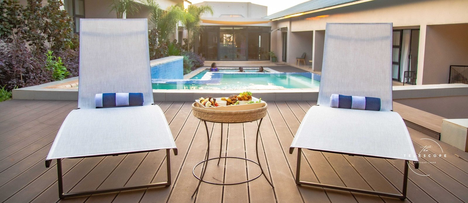 Sun loungers beside the swimming pool at The Telescope Boutique Lodge, Victoria Falls